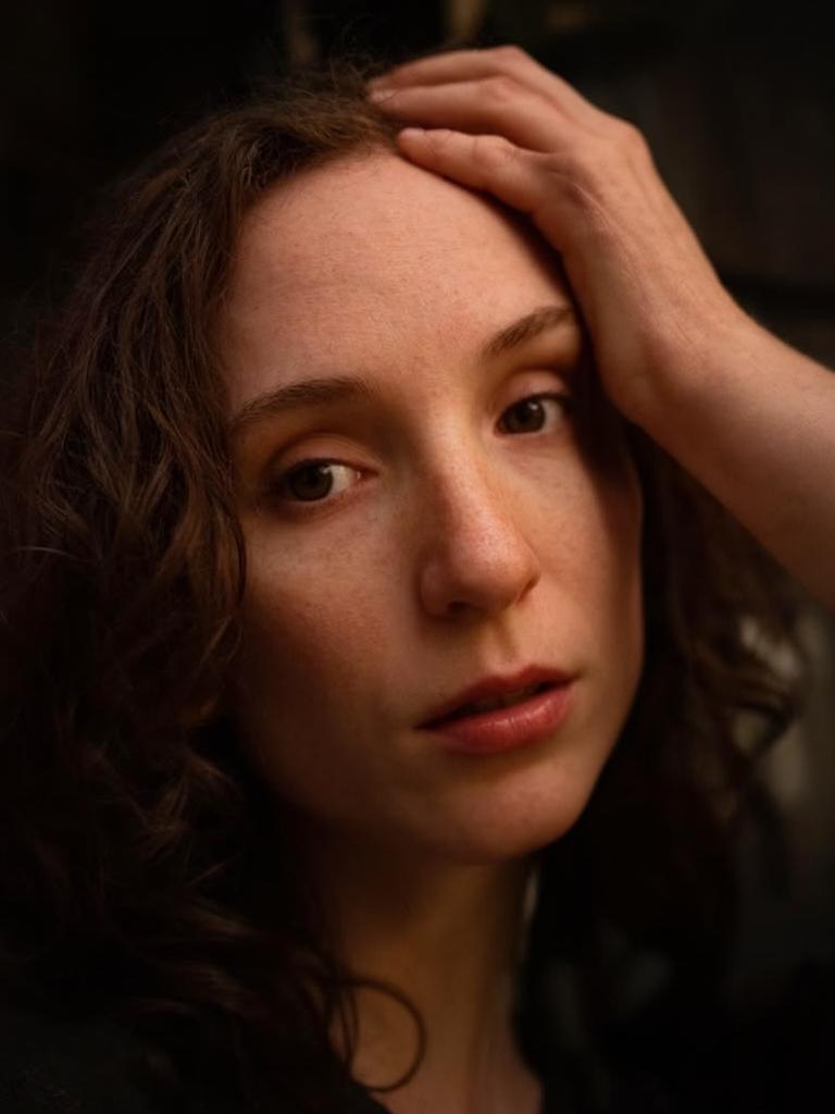 close-up portrait, contemplative, dramatic Rembrandt lighting, dark background