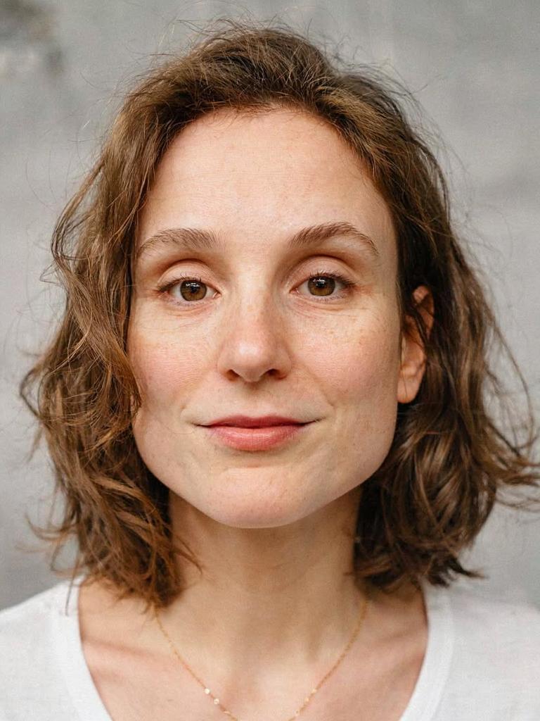 with a neutral expression, lit by a soft key